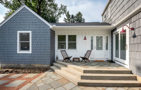 exterior bexley home addition with blue siding and patio