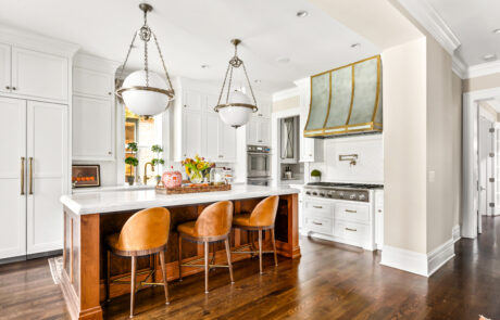 Columbus, Ohio Kitchen Remodel featuring brassy gold finishes and a custom concave front range hood.