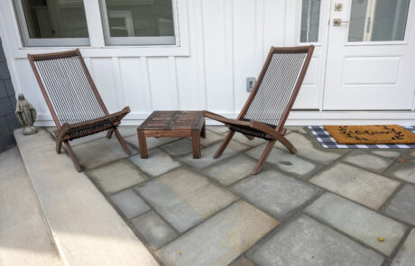 Two chairs on top of patio pavers
