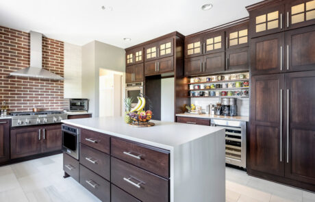 Kitchen reno with dark wood and various cabinet door panels.