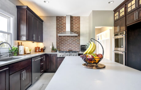 Kitchen with exposed brick over range.